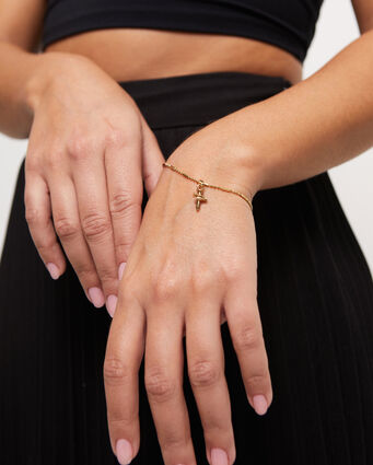 18K gold-plated cross-shaped charm.